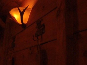 Antler wall-lights and wrought-iron hooks. Unheimlich gut!