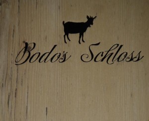 The logo for Bodo's Schloss is a goat wearing a bell. Not very Kensington